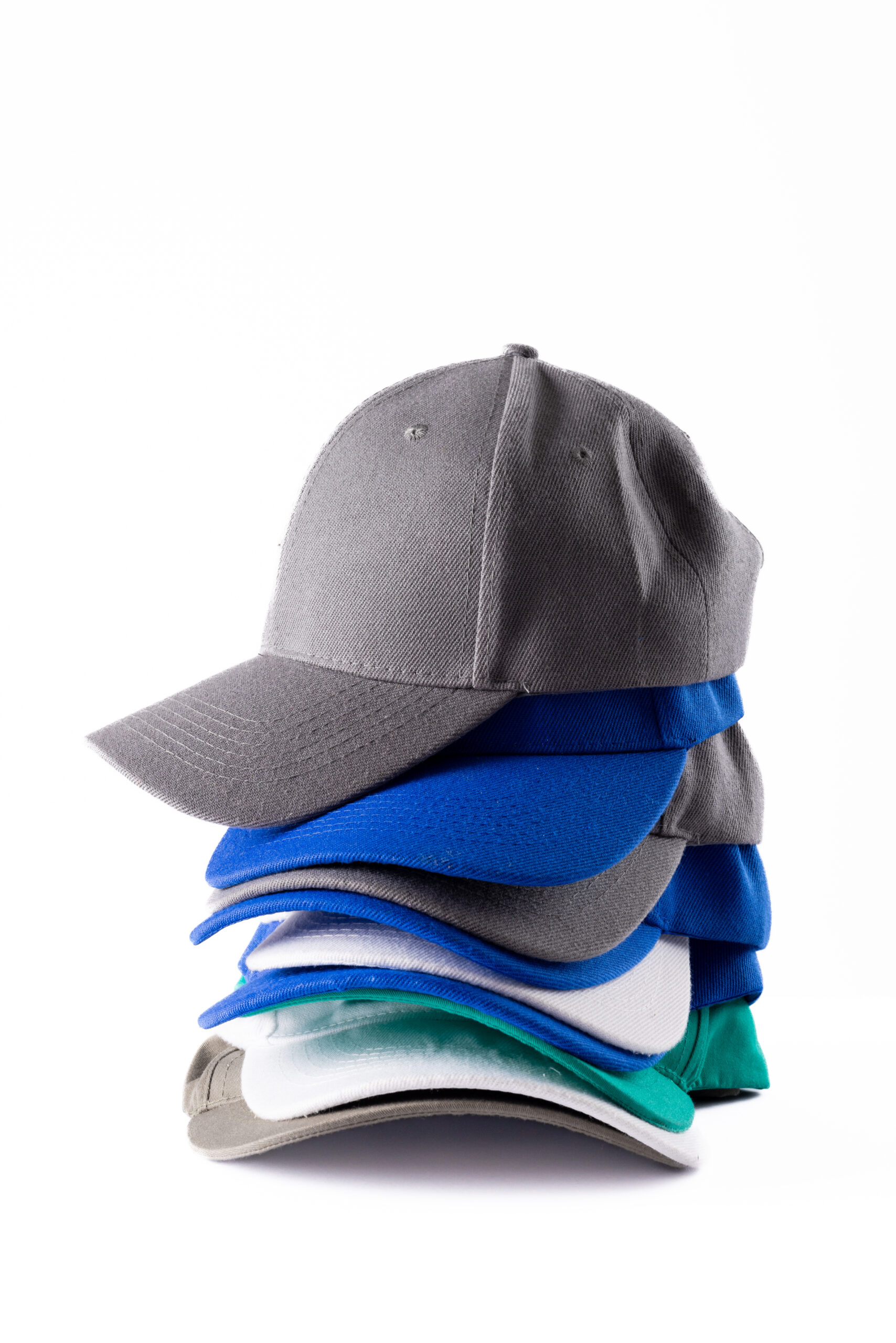 Vertical image of stack of cotton cups lying on white surface. Clothes, textiles, fashion, style and accessories concept.